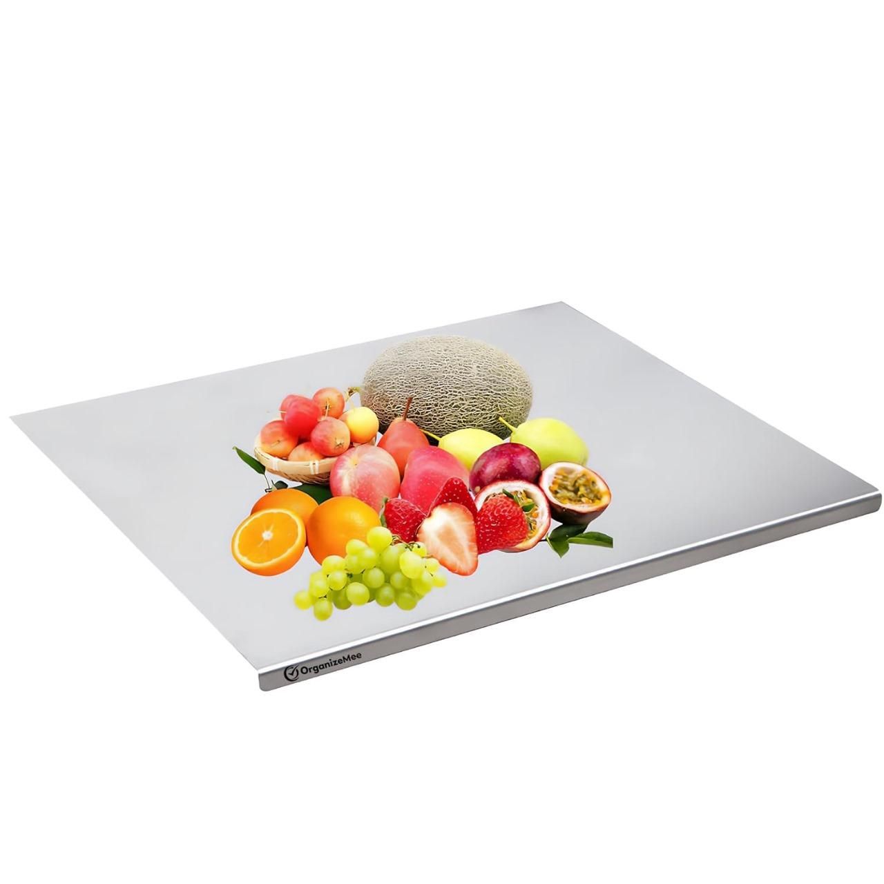 Cutting vegetables on stainless steel kitchen chopping board with built-in groove