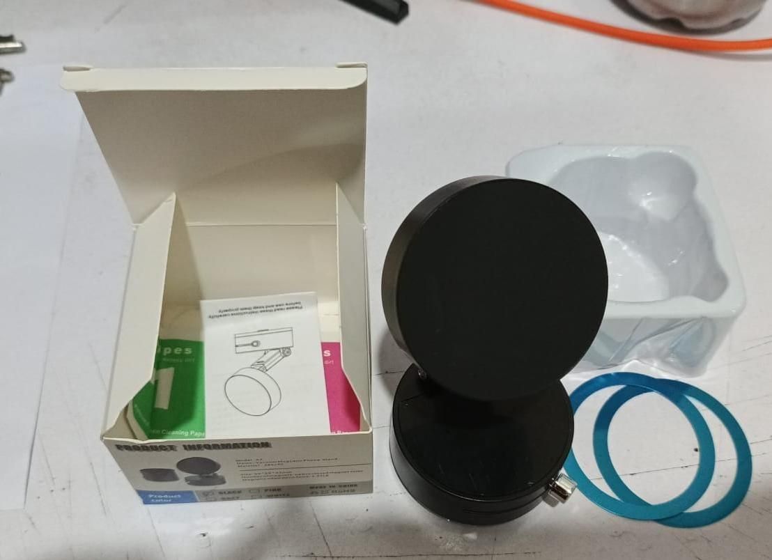 Close-up of on/off control switch on vacuum magnetic mobile holder with sleek black finish